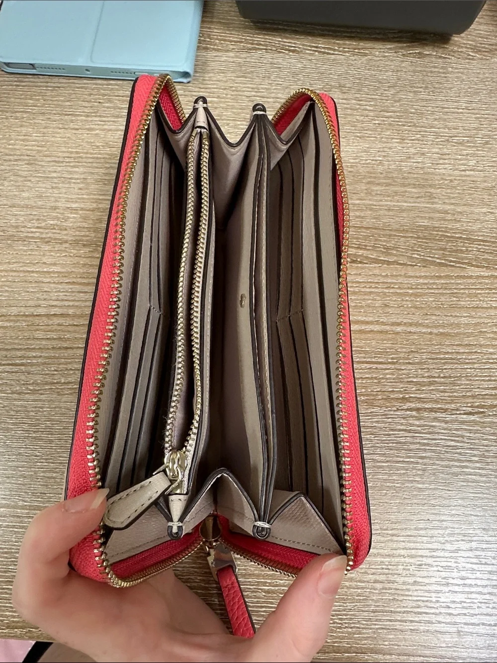 kate spade coral pink zip-around pebble leather wallet with wrist strap